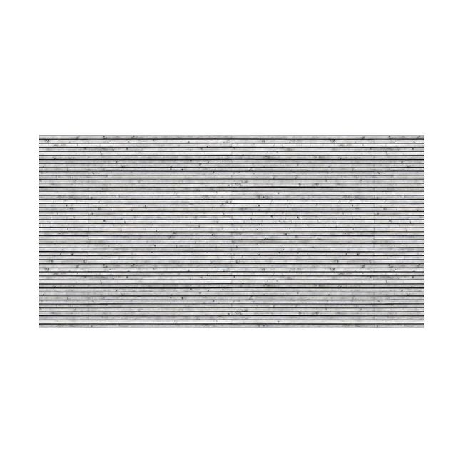 Teppich in Holzoptik Holzwand mit schmalen Leisten schwarz weiß