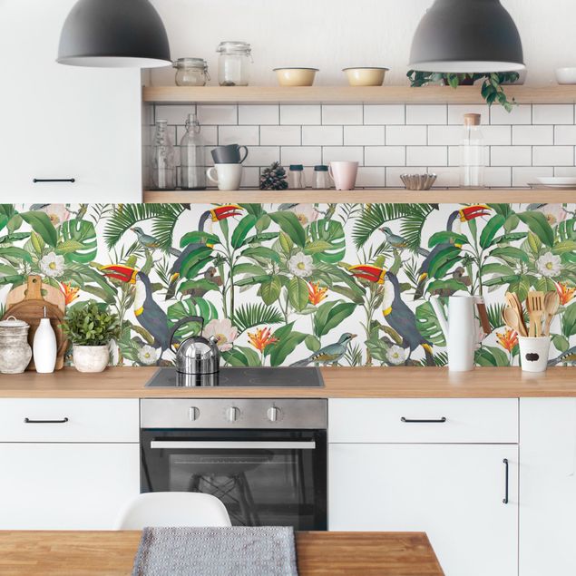 Küchenrückwand selbstklebend Tropischer Tukan mit Monstera und Palmenblättern