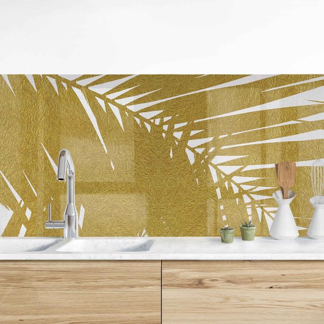 Platte Küchenrückwand Blick durch goldene Palmenblätter