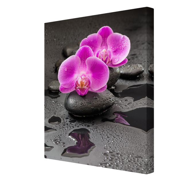 Leinwandbild - Pinke Orchideenblüten auf Steinen mit Tropfen - Hochformat 4:3