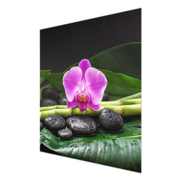 Glasbild - Grüner Bambus mit Orchideenblüte - Quadrat 1:1
