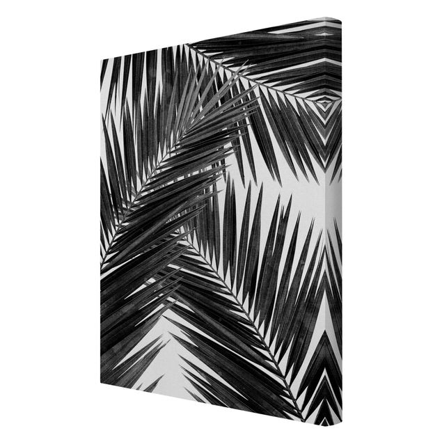 Leinwandbild - Blick durch Palmenblätter schwarz weiß - Hochformat 2:3