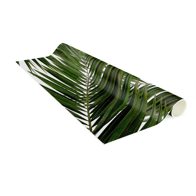 Teppich Blumen Blick durch grüne Palmenblätter