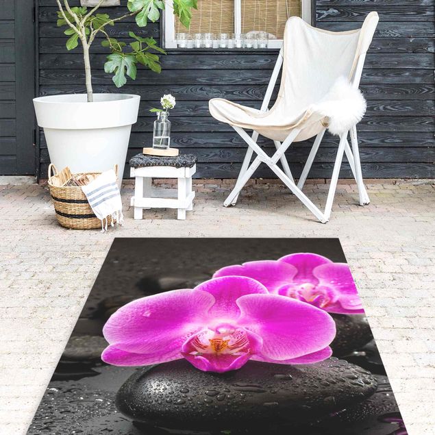 Vinyl-Teppich - Pinke Orchideenblüten auf Steinen mit Tropfen - Hochformat 1:2