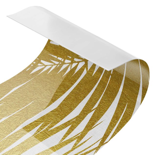 Motiv Küchenrückwand Blick durch goldene Palmenblätter