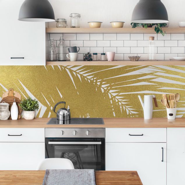 Küchenrückwand selbstklebend Blick durch goldene Palmenblätter